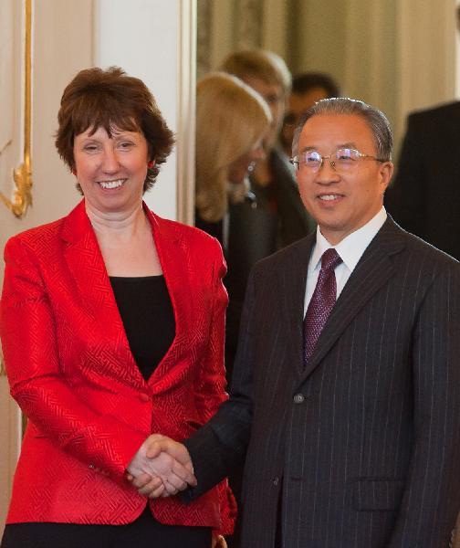 Chinese State Councilor Dai Bingguo (R, front) shakes hands with Catherine Ashton (L, front), high representative for foreign affairs and security policy and vice president of the European Commission, at the venue of the second round of China-EU strategic dialogue, in Godollo, some 30 kilometers away from Budapest, Hungary, May 12, 2011. [Attila Volgyi/Xinhua]