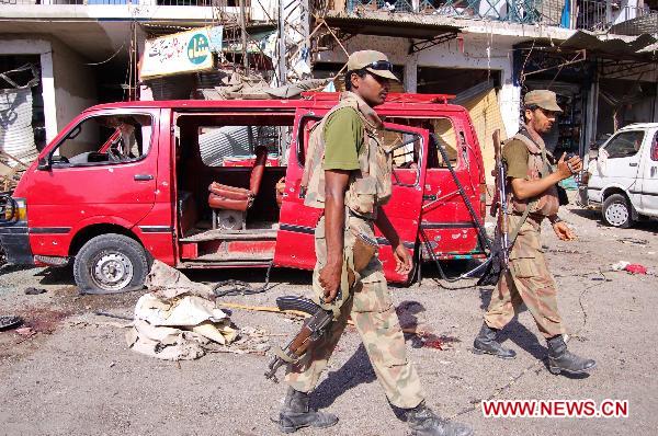 Pakistani soldiers cordon off the blast site in northwest Pakistan&apos;s Charsadda on May 13, 2011. [Xinhua/Saeed Ahmad]