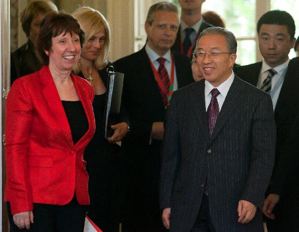 Chinese State Councilor Dai Bingguo (R, front) and Catherine Ashton (L, front), high representative for foreign affairs and security policy and vice president of the European Commission, arrive at the venue of the second round of China-EU strategic dialogue, in Godollo, some 30 kilometers away from Budapest, Hungary, May 12, 2011.[Xinhua]