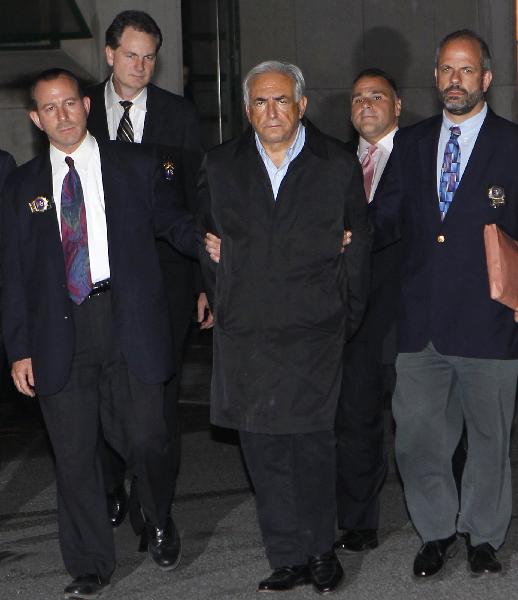 International Monetary Fund (IMF) Managing Director Dominique Strauss-Kahn (front 2nd R) leaves New York Police Department Special Victims Unit headquarters in Harlem May 15, 2011.