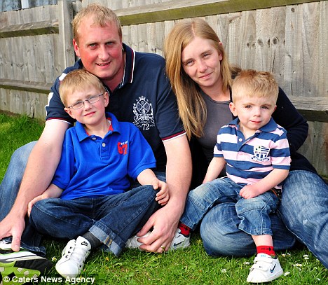 Brave little boy: Oliver Jebson (right) who cannot feel pain with his parents Hayley, 25, and Dean, 27, and brother Lewis.