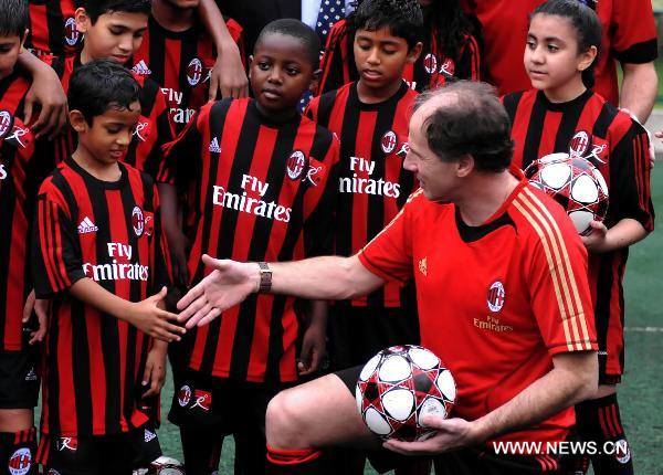 Italian football legend Franco Baresi (R front) shakes hands with little players after the launch ceremony of AC Milan Soccer Schools in Hong Kong, south China, May 16, 2011. (Xinhua/Lo Ping Fai)