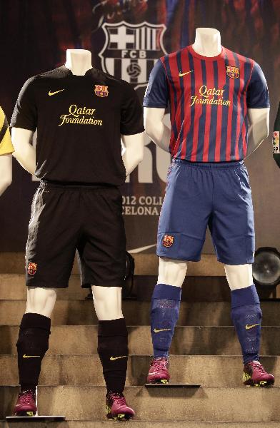 The new Barcelona jerseys for the 2011-2012 season with the Qatar Foundation logo are displayed during a presentation at Camp Nou stadium in Barcelona May 17, 2011. (Xinhua/Reuters Photo) 