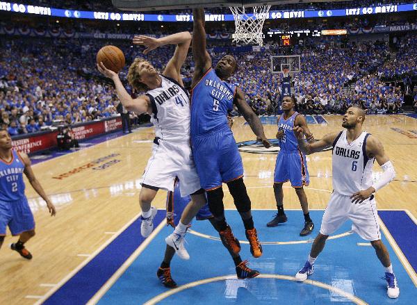 Dallas Mavericks power forward Dirk Nowitzki (41) goes to the basket against Oklahoma City Thunder center Kendrick Perkins (5) in the first half during Game 1 of the NBA Western Conference Final basketball playoff in Dallas, Texas May 17, 2011. (Xinhua/Reuters Photo) 