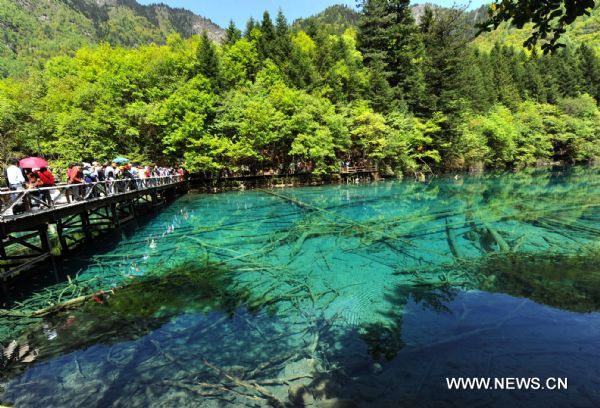 Tourists visit the Jiuzhaigou scenery spot in southwest China's Sichuan Province, on May 18, 2011. After three years' remedy and recovery, Jiuzhaigou, a renowned resort once had been badly affected by a deadly earthquake, is booming in its tourism business, with the daily reception number reaching nearly 10,000 in May. (Xinhua/Chen Haining) 
