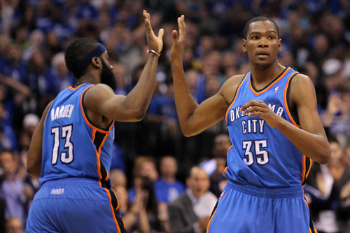 (R) Kevin Durant of the Oklahoma City Thunder gives a five to teammate James Harden in the second half while taking on the Dallas Mavericks in Game 2 of the Western Conference Finals during the 2011 NBA Playoffs at American Airlines Center on May 19, 2011 in Dallas, Texas. [Source: Sina.com]