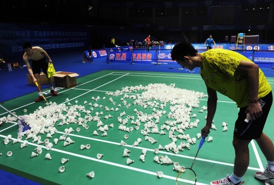 Chinese badminton players collect badmintons after training on May 18, 2011. Chinese badminton team is determined to fight for its fourth-straight title of Sudirman Cup to be held from May 22 to 29.