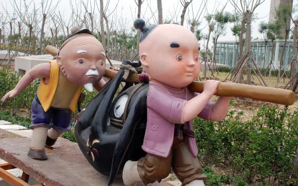Photo taken on May 22, 2011 shows the cartoon sculptures of Chinese traditional characters, before the gate of the National Animation Industry Park, in Tianjin, north China. 