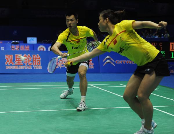 China's Ma Jin (R) and Xu Chen compete against Germany's Michael Fuchs and Birgit Michels during the 2011 Sudirman Cup in Qingdao, east China's Shandong Province, May 22, 2011. The Chinese pair won the match 2-0. (Xinhua/Li Ziheng)