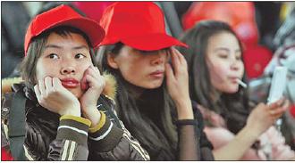 A handful among 177 newly hired Foxconn workers from Guizhou wait at the Guiyang railway station on March 1 before heading to Chengdu.