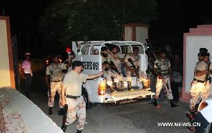 Pakistani troops arrive at Pakistan military air base after an attack by militants in southern Pakistan's Karachi on May 23, 2011. At least four people were killed and one plane was destroyed following attacks launched by terrorists late Sunday night at a Pakistan air base in Karachi. [Toheed/Xinhua]