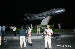 Pakistani troops arrive at the Pakistan military air base after an attack by militants in southern Pakistan's Karachi on May 23, 2011. At least four people were killed and one plane was destroyed following attacks launched by terrorists late Sunday night at a Pakistan air base in Karachi. [Toheed/Xinhua] 