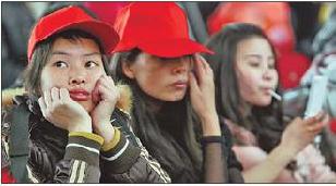 A handful among 177 newly hired Foxconn workers from Guizhou wait at the Guiyang railway station on March 1 before heading to Chengdu.