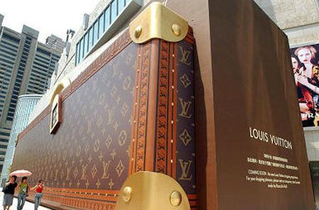 Shoppers And Louis Vuitton Hoarding