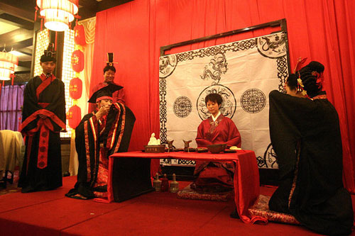 The bridegroom and bride proposed a wedding toast by sitting left-to-right according to Han customs during the service in Gansu, capital of Northwest China's Lanzhou province on Sunday, May 22, 2011. 