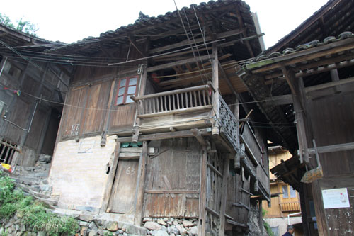 The photo taken on Monday, May 23, 2011 shows a typical cottage in the Nanhua Miao village. The village, as part of Three Trees Town, is located roughly 5 kilometers from the city of Kaili, the capital of Qiandongnan Miao and Dong Autonomous Prefecture, southwest China's Guizhou Province. The cottages (Diaojiaolou in Chinese) are built around the mountain. It is well known for beautiful natural scenery and rich customs of the Miao people. [Photo: CRIENGLISH.com/Yu JingJing] 