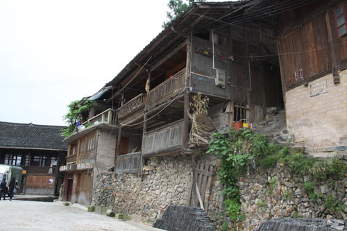 The photo taken on Monday, May 23, 2011 shows a typical cottage in the Nanhua Miao village. The village, as part of Three Trees Town, is located roughly 5 kilometers from the city of Kaili, the capital of Qiandongnan Miao and Dong Autonomous Prefecture, southwest China's Guizhou Province. The cottages (Diaojiaolou in Chinese) are built around the mountain. It is well known for beautiful natural scenery and rich customs of the Miao people. [Photo: CRIENGLISH.com/Yu JingJing]