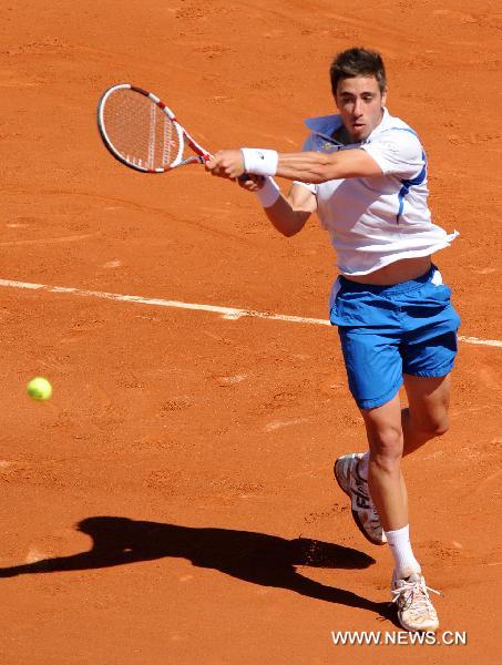 Maxime Teixeira of France returns the ball during the second round match of men's singles against Roger Federer of Switzerland in the French Open tennis tournament at the Roland Garros in Paris May 25, 2011. Federer won 3-0. (Xinhua/Xu Liang) 
