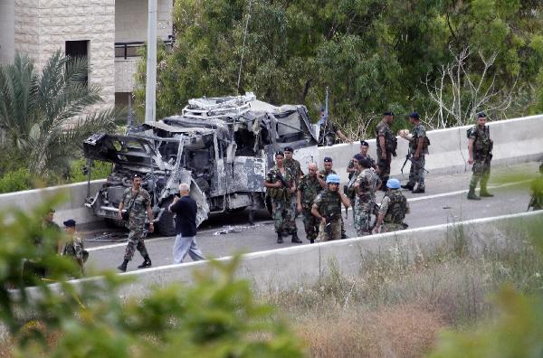 Lebanese and U.N soldiers inspect a damaged UN vehicle at Remaily village near the southern Lebanese port city of Sidon May 27, 2011. [Xinhua/Reuters Photo]