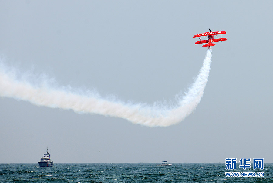 An aircraft performs aerobatics over Johns Beach in New York, the United States, May 28, 2011. 