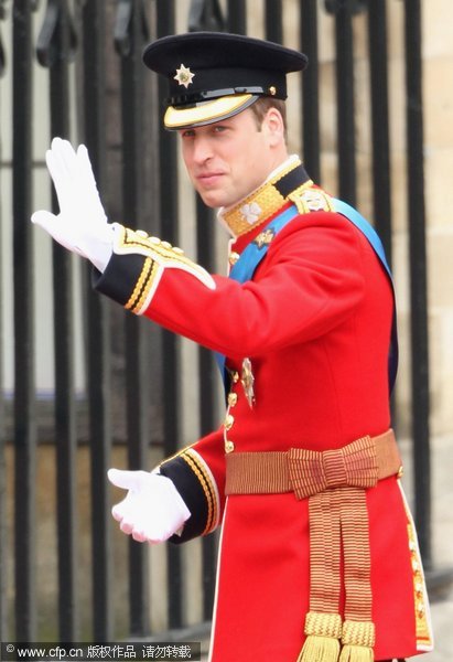 Prince William waves to the crowd as he arrives with Prince Harry for the Royal Wedding of Prince William to Catherine Middleton at Westminster Abbey on April 29, 2011 in London.