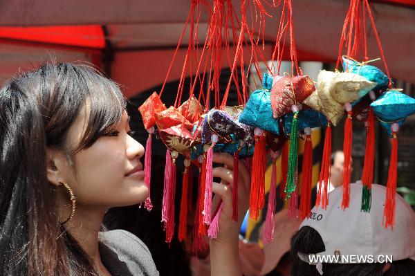 A girl views fragrant bags at the traditional rice food festival held in Taipei, south China's Taiwan, May 29, 2011. A traditional rice food festival kicked off in Taipei on Sunday, attracting many citizens to taste delicious snacks.