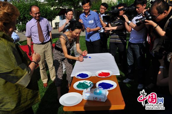 Maggie Cheung, UNICEF ambassador in China paints little footprints, signalling the progressing cause of child welfare in China. [Pierre Chen / China.org.cn]