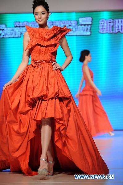 A model presents a wedding dress by designer Walter Ma during the Second Asian Wedding and Design Competition in Hong Kong, south China, June 4, 2011. Final result of the fashion contest will be released on Aug. 27, 2011, organizers announced in a press conference Saturday together with a shortlist of 30 contestants. [Song Zhenping/Xinhua]