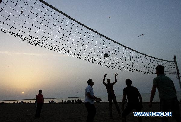 People play Volleyball on the beach at Anzali port in northern Iran, June 5, 2011. At least 13 people were drowned in the Caspian sea during a three day national holiday in Iran, acording to the local media. [Xinhua/Ahmad Halabisaz]