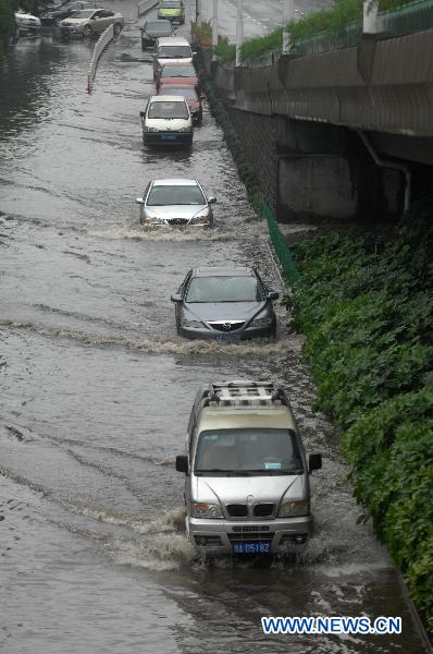 Vehicles run on the flooded street in Hangzhou, capital of east China&apos;s Zhejiang Province, June 6, 2011. Continued rainfall hit Hangzhou in recent days, disturbing the city&apos;s traffic. Multiple places in Zhejiang have been suffering from drought since spring of this year. [Xinhua] 