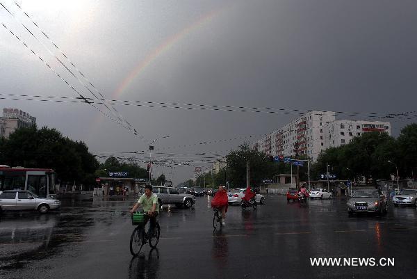 An arch of rainbow is seen over the sky after a thunderstorm poured in Beijing, capital of China, June 7, 2011. 