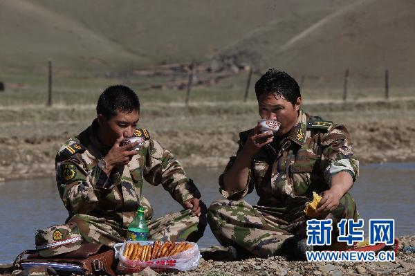 Queji Nima and his colleague take a rest on their way to share firefighting knowledge with local Tibetans. 