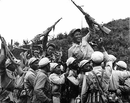 The armies of China and Korea, fighting shoulder-to-shoulder, drove the American invaders back to the vicinity of the 38th Parallel. Soldiers are shown here celebrating the victory.