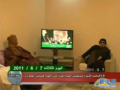 Footage broadcast by Libyan state TV shows Muammar Gaddafi greeting a tribal leader in an unknown location, June 7, 2011.
