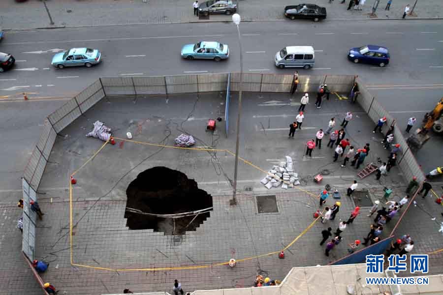 A road collapsed June 9, 2011, near a subway station construction site in Dalian, the second largest city in northeast China&apos;s Liaoning Province. Police have restricted traffic on several streets near the cave-in. The cause of the accident is still under investigation. [Photo/Xinhua]