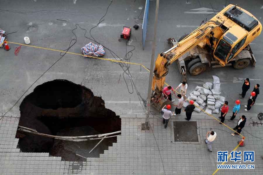 A road collapsed June 9, 2011, near a subway station construction site in Dalian, the second largest city in northeast China&apos;s Liaoning Province. Police have restricted traffic on several streets near the cave-in. The cause of the accident is still under investigation. [Photo/Xinhua]