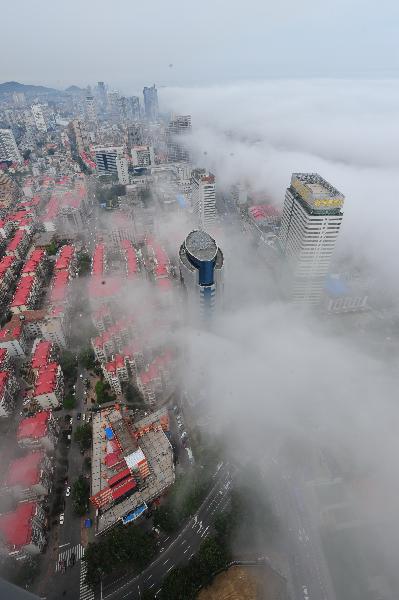Photo taken on June 9, 2011 shows buildings hovered by silk-like advection fog in Yantai, east China's Shandong Province. [Xinhua/Chu Yang]