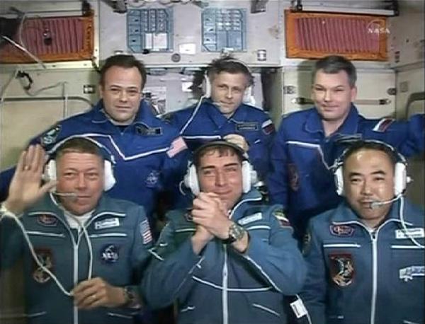 Expedition 28 Flight Engineers (L-R) Mike Fossum, Sergei Volkov and Japan Aerospace Agency astronaut Satoshi Furukawa and (back row, L-R) Ron Garan, International Space Station Commander Andrey Borisenko and Alexander Samokutyaev wave at the end of a post docking news conference in this image from NASA TV June 9, 2011. 