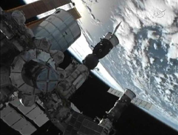 The Russian Soyuz TMA-02M spacecraft with Expedition 28 Flight Engineers Mike Fossum, Sergei Volkov and Japan Aerospace Agency astronaut Satoshi Furukawa aboard sits docked to the International Space Station before hatches open between the two spacecraft in this image from NASA TV June 9, 2011. 