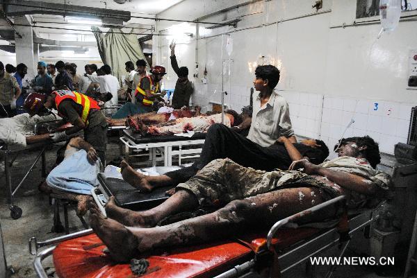 Injured blast victims wait for medical treatments at a hospital in Peshawar, northwest Pakistan, June 12, 2011.[Umar Qayyum/Xinhua] 