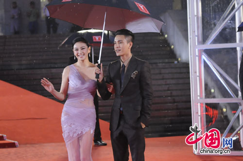 Chinese actress Kitty Zhang (L) and actor Chen Kun walk the red carpet at the opening ceremony of the 14th Shanghai International Film Festival at Shanghai Grand Theater on rainy Saturday. [Pang Li/China.org.cn]