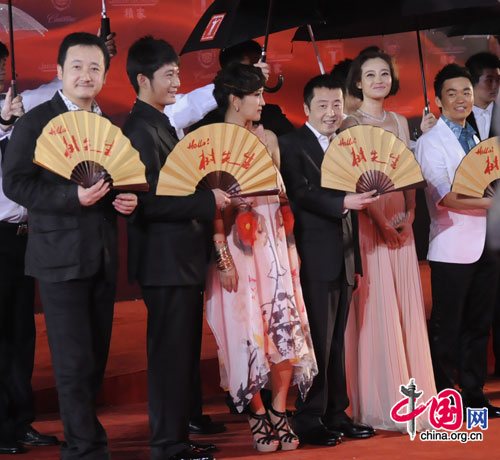 Cast members of the movie 'Mr. Tree' and director Jia Zhangke (third from the right) walk the red carpet at the opening ceremony of the 14th Shanghai International Film Festival at Shanghai Grand Theater on rainy Saturday. [Pang Li/China.org.cn] 