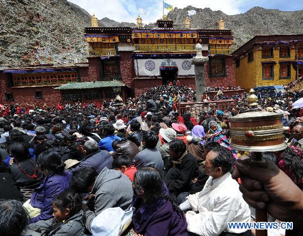 Worshippers attend the Buddha Tangka painting unfolding ceremony in Curpu Temple, 70 kilometers away from Lhasa, capital of southwest China&apos;s Tibet Autonomous Region, June 12, 2011. The annual Buddha Tangka painting unfolding ceremony was held in Curpu Temple on Sunday. [Xinhua]