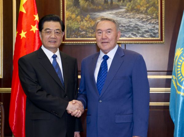 Chinese President Hu Jintao (L) is greeted by Kazakh President Nursultan Nazarbayev upon his arrival at the airport VIP room in Astana, capital of Kazakhstan, June 12, 2011. Hu Jintao arrived in Astana Sunday for a state visit and an annual summit of the Shanghai Cooperation Organization (SCO). [Photo/Xinhua]