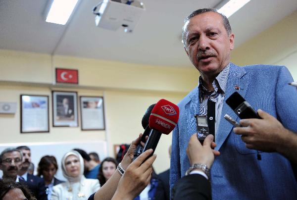 Turkish Prime Minister Recep Tayyip Erdogan speaks to reporters after casting his vote, in Istanbul, Turkey, on June 12, 2011. [Xinhua Photo]