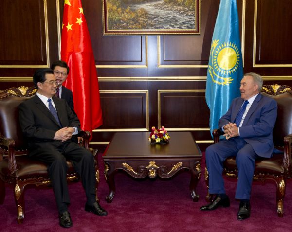 Chinese President Hu Jintao (L) is greeted by Kazakh President Nursultan Nazarbayev upon his arrival at the airport VIP room in Astana, capital of Kazakhstan, June 12, 2011. Hu Jintao arrived in Astana Sunday for a state visit and an annual summit of the Shanghai Cooperation Organization (SCO). [Xinhua Photo]