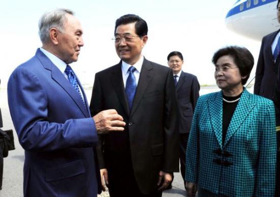 Chinese President Hu Jintao (C, front) and his wife Liu Yongqing (R) are greeted by Kazakh President Nursultan Nazarbayev upon their arrival in Astana, capital of Kazakhstan, June 12, 2011. Hu Jintao arrived in Astana Sunday for a state visit and an annual summit of the Shanghai Cooperation Organization (SCO).