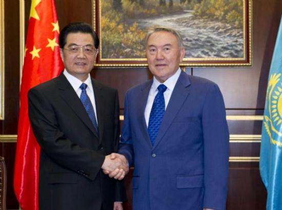 Chinese President Hu Jintao (L) is greeted by Kazakh President Nursultan Nazarbayev upon his arrival at the airport VIP room in Astana, capital of Kazakhstan, June 12, 2011. Hu Jintao arrived in Astana Sunday for a state visit and an annual summit of the Shanghai Cooperation Organization (SCO).