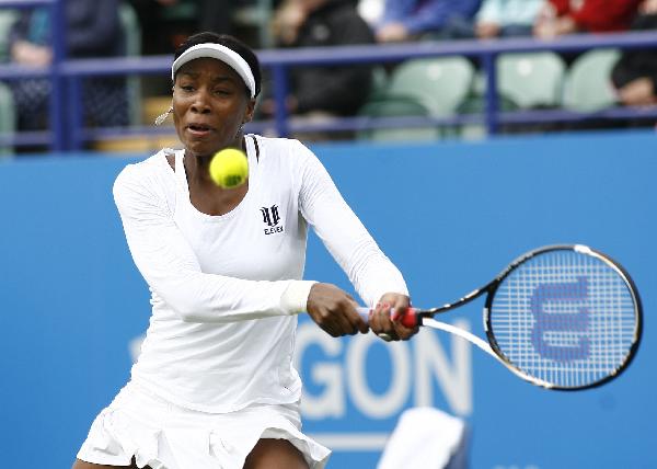 Venus Williams of the United States returns a shot during her first round match against Andrea Petkovic of Germany at 2011's AEGON International in Eastbourne, Britain June 13, 2011. Williams won 2-1. (Xinhua/Chen Hongbo)