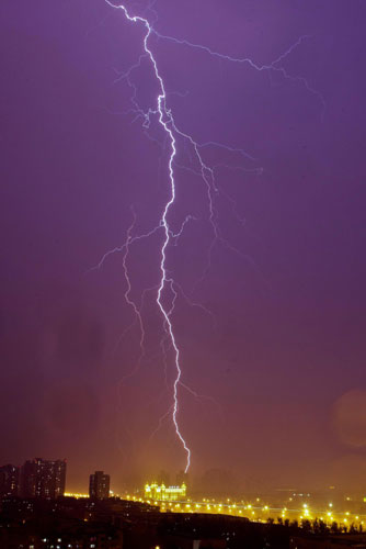A flash of lightning lights the night sky in Beijing, June 14, 2011. A thunder and lightning storm struck the Chinese capital city on Tuesday evening. [Photo/Xinhua]
